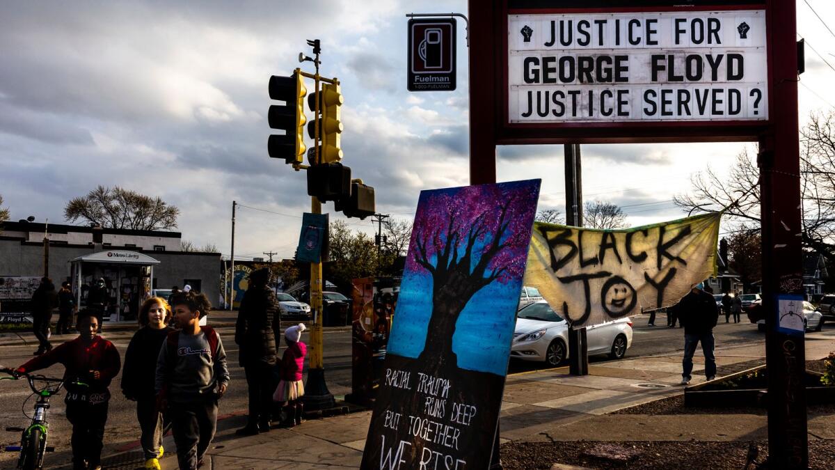 Young boys walk past George Floyd Square in Minneapolis. Photo: AFP