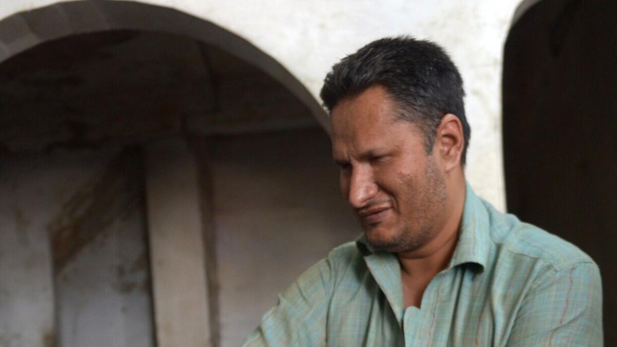 Pakistani blind mechanic Asif Patel working at his workshop in Karachi.