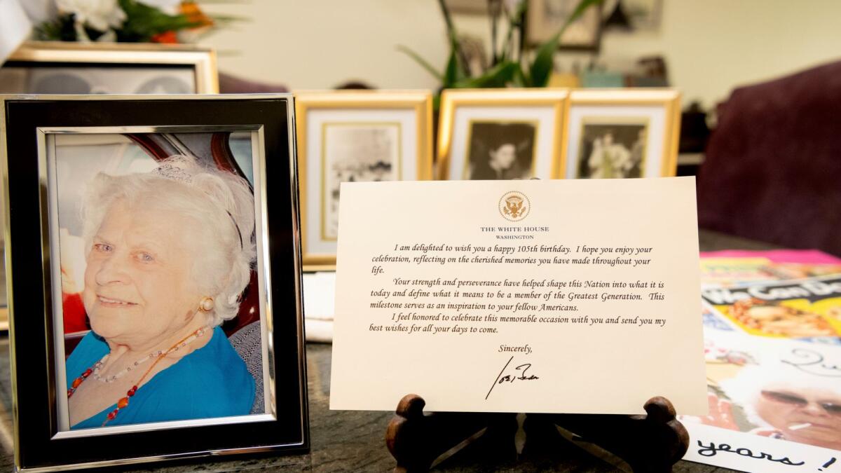 A note from President Joe Biden is seen placed among photos of Primetta Giacopini, who died of Covid-19 in Richmond, California, on Sept 27, 2021.