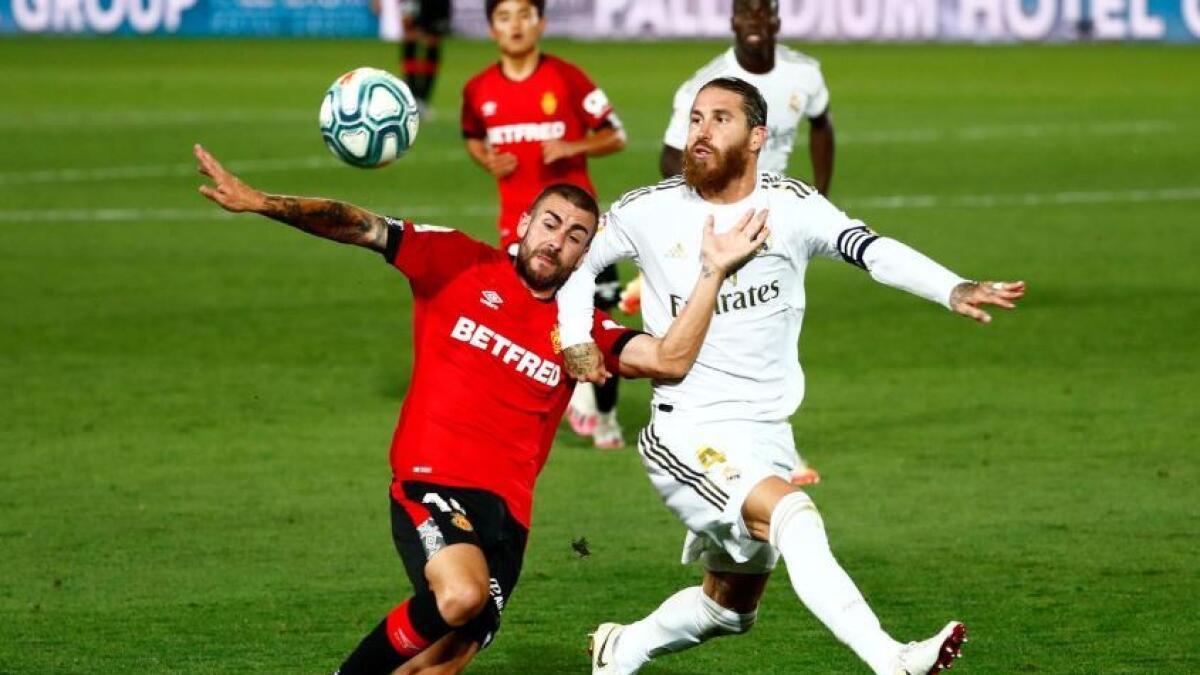 Real Madrid's Sergio Ramos vies for the ball with Mallorca's Dani Rodriguez (Reuters)