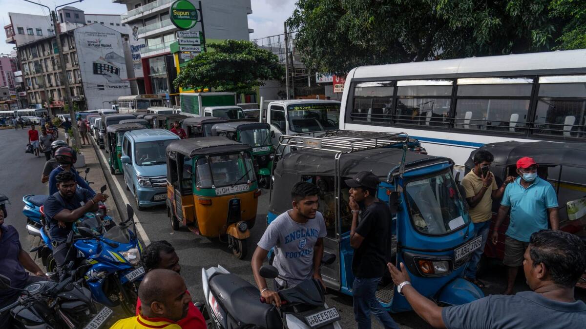 Sri Lankans wait in queue to buy petrol at a fuel station, in Colombo. The Asian Development Bank has downgraded its forecasts for growth in the region, citing the war in Ukraine, rising interest rates aimed at fighting decades-high inflation and China's slowing economy. — AP