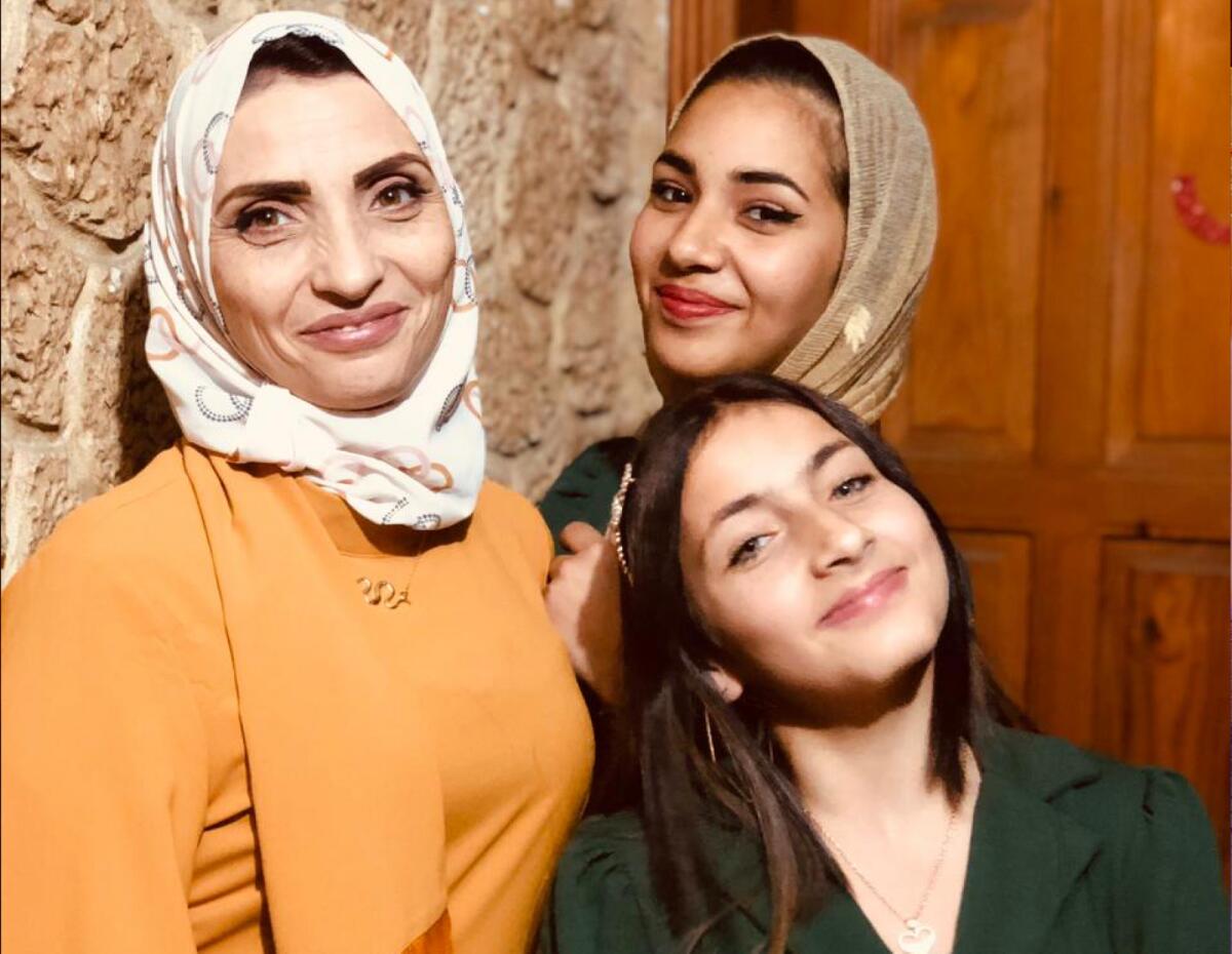 Gaza resident VM with her daughters. Photo: Supplied