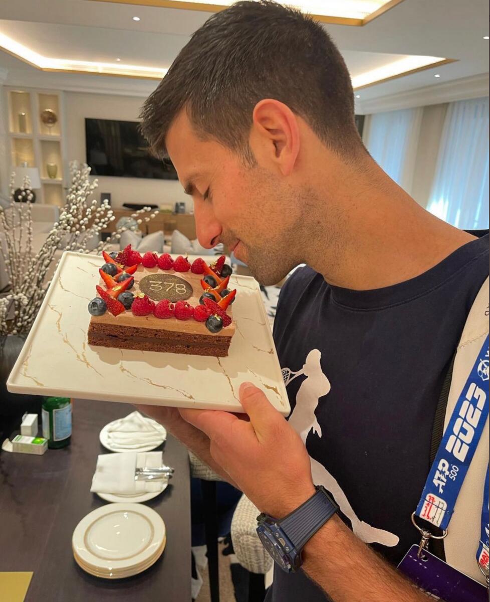 Novak Djokovic celebrates with a cake after becoming the first player to top the world tennis rankings for an incredible 378 weeks. — Twitter