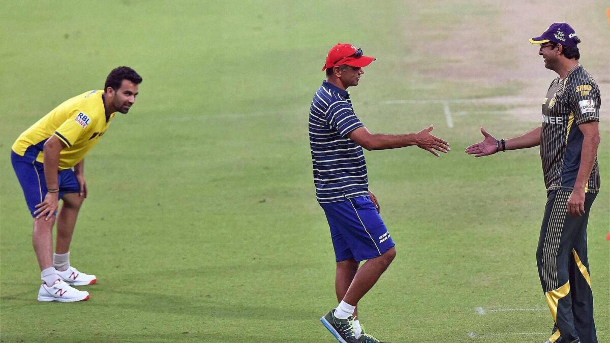 Delhi Daredevils mentor Rahul Dravid greets KKR bowling coach Wasim Akram as Zaheer Khan looks on in Kolkata on Saturday. 