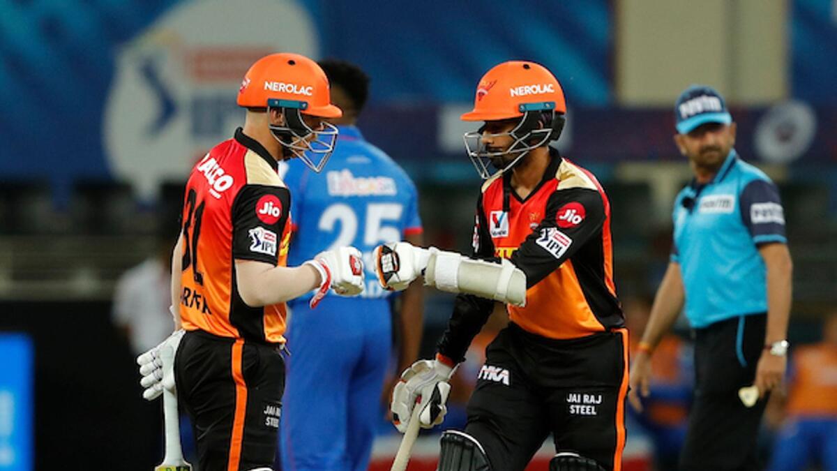 Sunrisers Hyderabad's Wriddhiman Saha (right) and David Warner fist bump during the match against the Delhi Capitals in Dubai on Tuesday night. BCCI/IPL