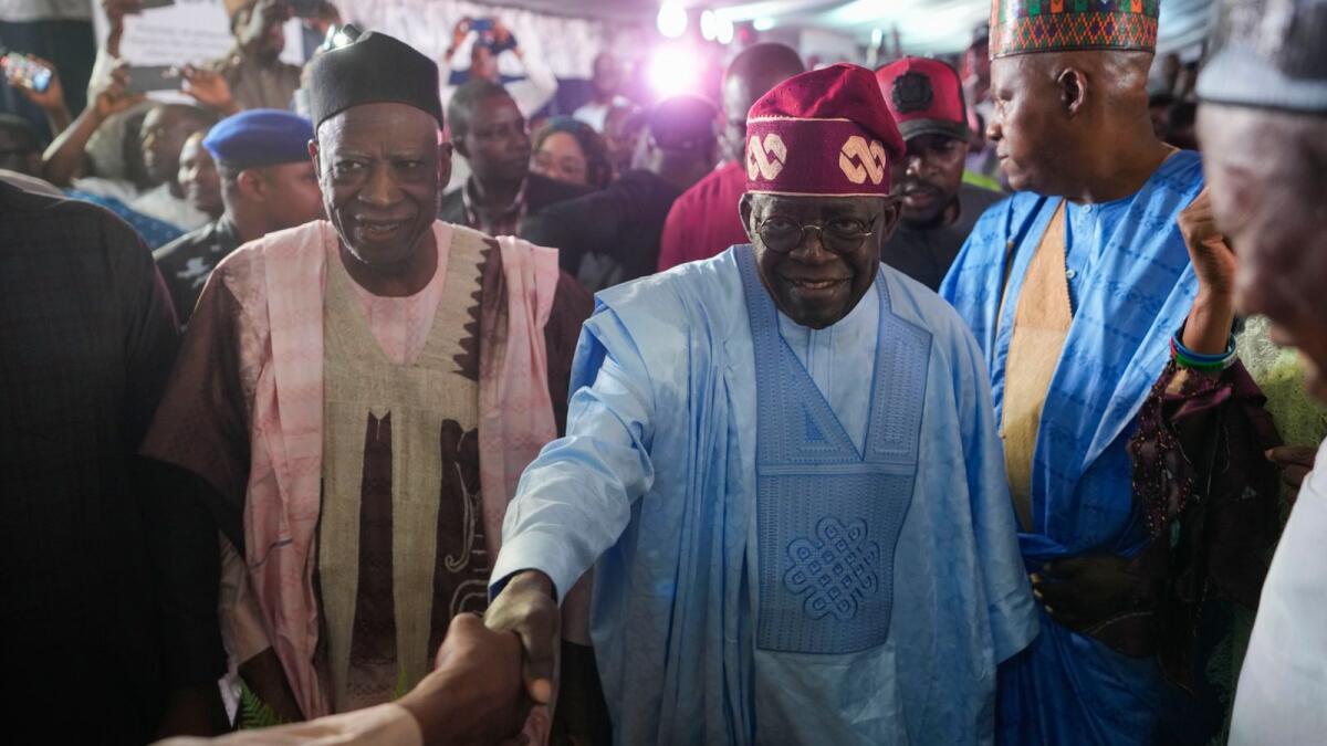 Bola Tinubu (center) celebrates with supporters at the party’s campaign headquarters after winning the presidential elections in Abuja. — AP