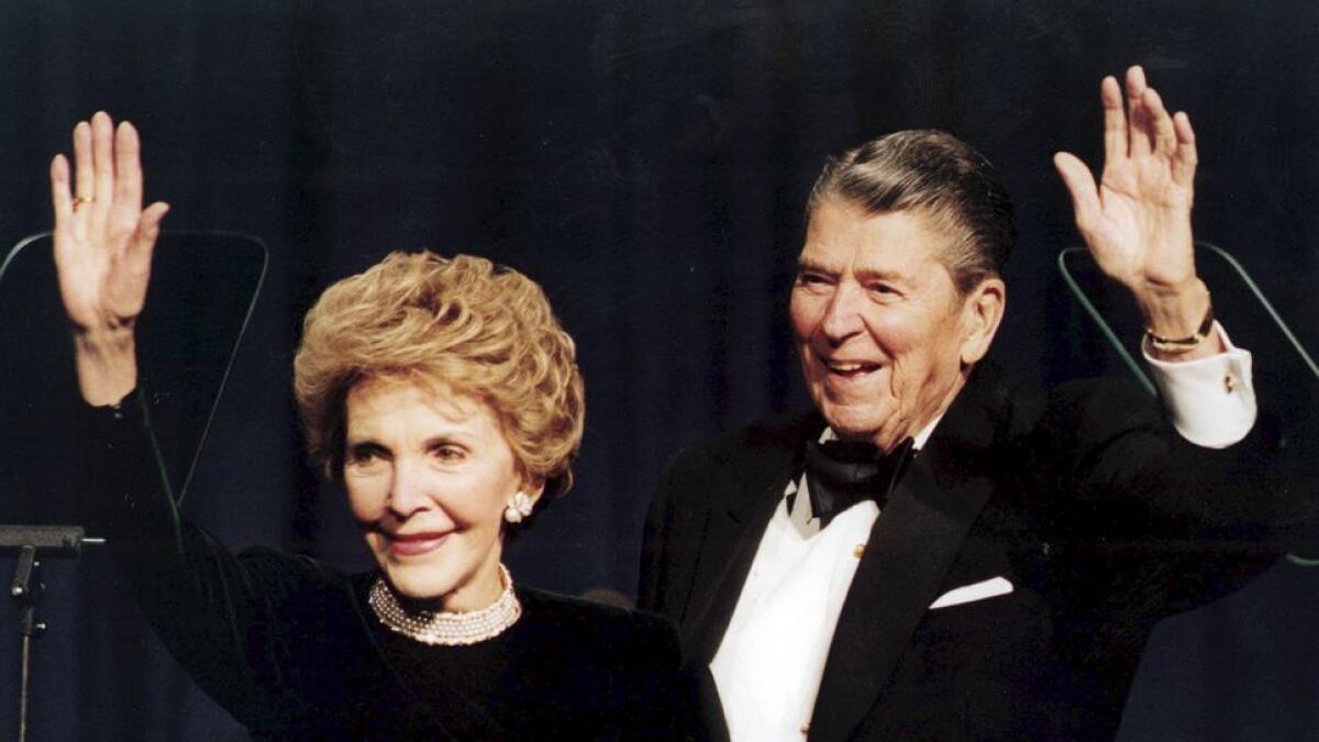 Former US President Ronald Reagan and his wife Nancy wave while attending a gala celebrating his 83rd birthday in Washington. –Reuters file photo