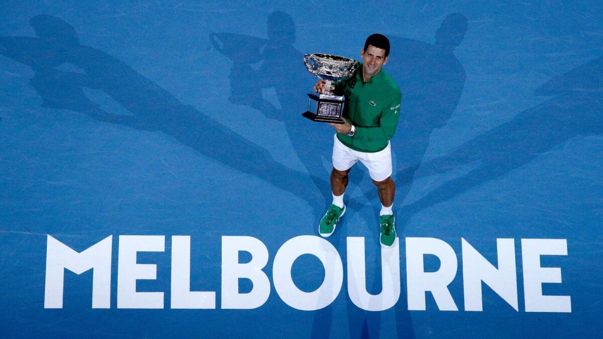 FILE - In this Feb. 3, 2020, file photo, Serbia's Novak Djokovic holds the Norman Brookes Challenge Cup after defeating Austria's Dominic Thiem in the men's singles final of the Australian Open tennis championship in Melbourne, Australia. Photo: AP