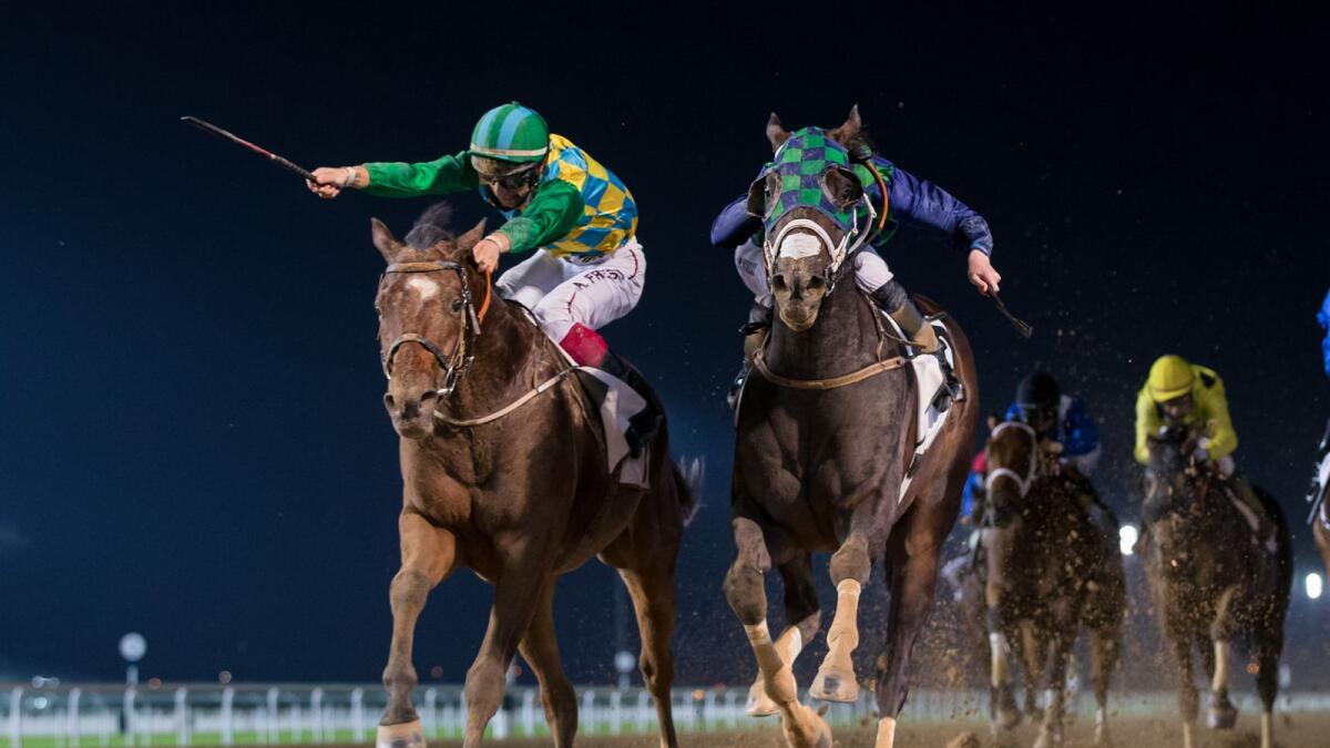 Casey Jones (left), ridden by Antonio Fresu, pips Thegreatcollection to the post in the feature race at the Meydan Racecourse in Dubai on Thursday night. — Dubai Racing Club