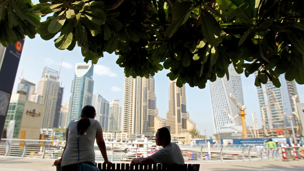 A visitor enjoys the Marina Skyline view at the Dubai Marina walk. -Photo by Rahul Gajjar/Khaleej Times