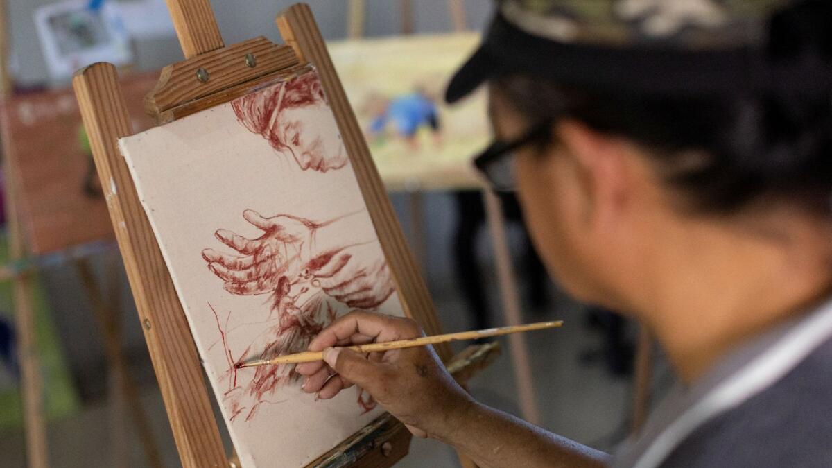 Filipino artist Elito Circa, 52, paints with his own blood in his studio in Nueva Ecija province, the Philippines. — Reuters
