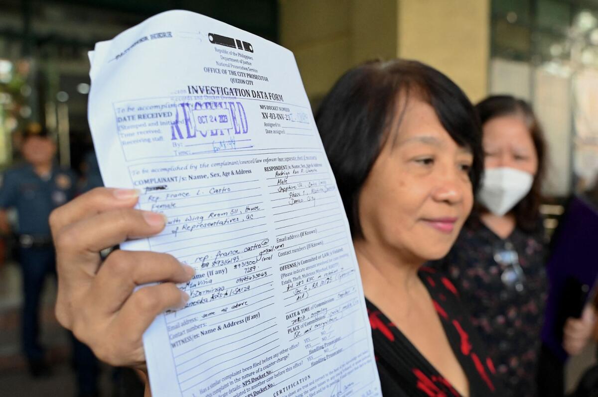 Philippine legislator France Castro shows a document after filing a criminal complaint against former Philippine president Rodrigo Duterte, at the Office of the Prosecutor in Quezon City on Tuesday following the malicious threats made by Duterte in a television interview. — AFP