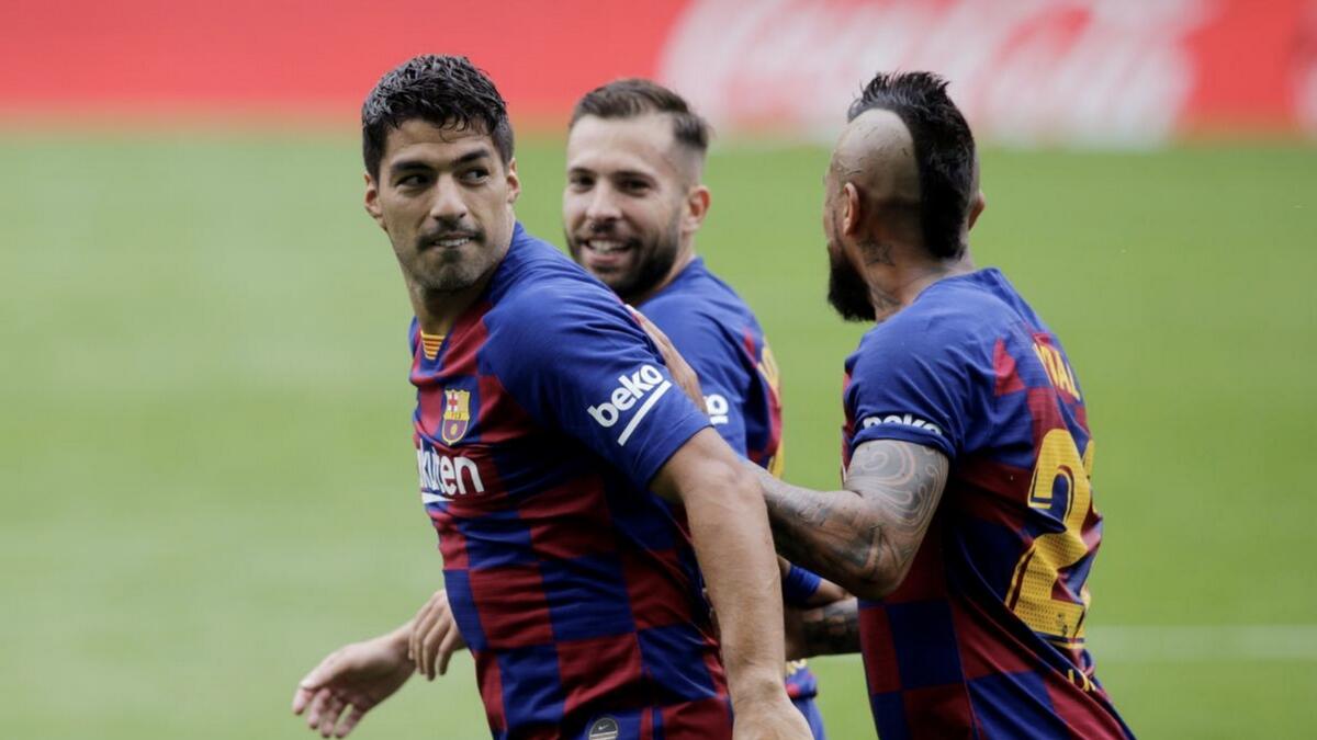 Barcelona's Luis Suarez celebrates scoring their first goal with teammates. - Reuters
