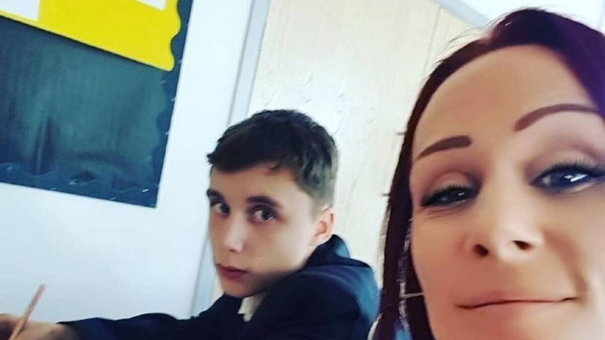 Mother sits next to son in school to stop him from being rude