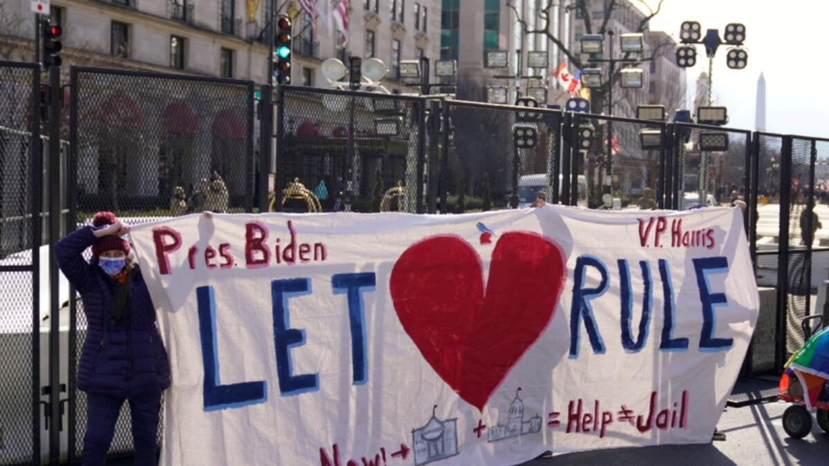 President Joe Biden supporters hold up a sign during 59th Presidential Inauguration in Washington.— AP