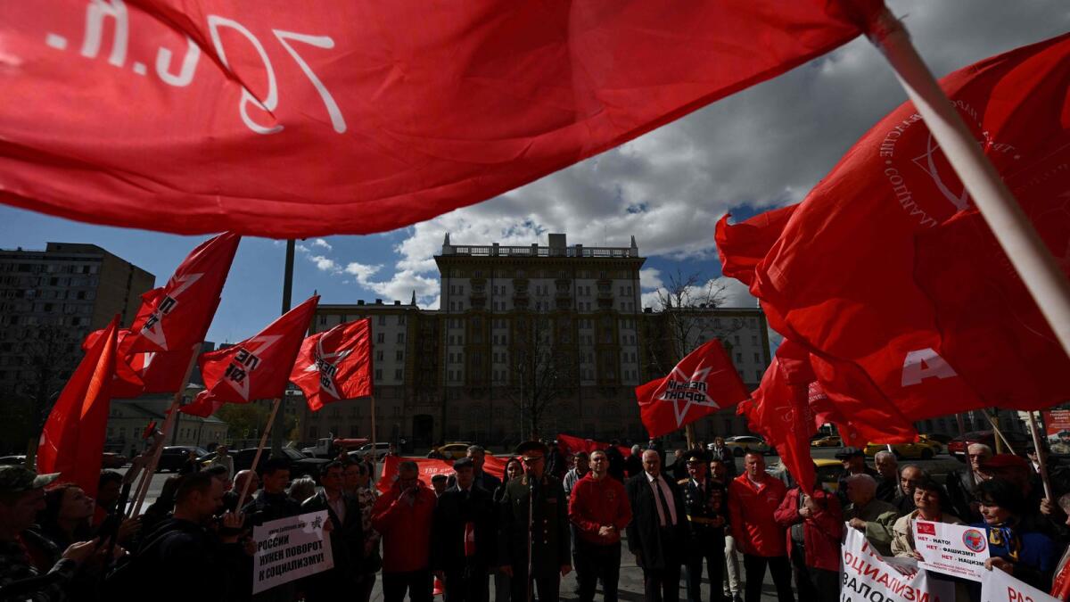 Russian Communist party supporters hold red flags and banners, as they protest against the foreign policy of the US and Nato in front of the US Embassy in Moscow on Saturday. — AFP