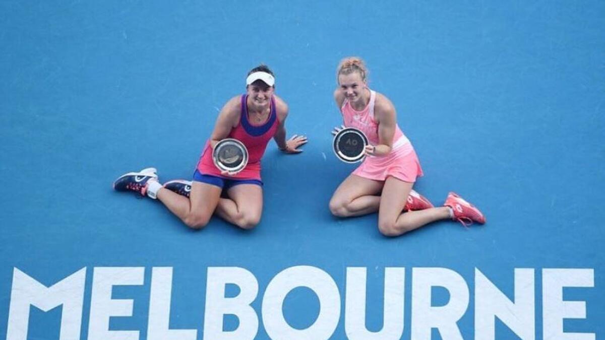 Elise Mertens and Aryna Sabalenka pose with the trophy. (WTA Twitter)