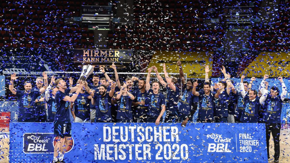 The team of Alba Berlin celebrates with the trophy after the German basketball Bundesliga final second-leg match between MHP Riesen Ludwigsburg and Alba Berlin in Munich, southern Germany on June 28, 2020. Photo: AFP