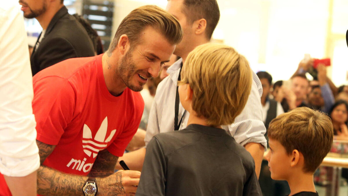 David Beckham interacts with kids.