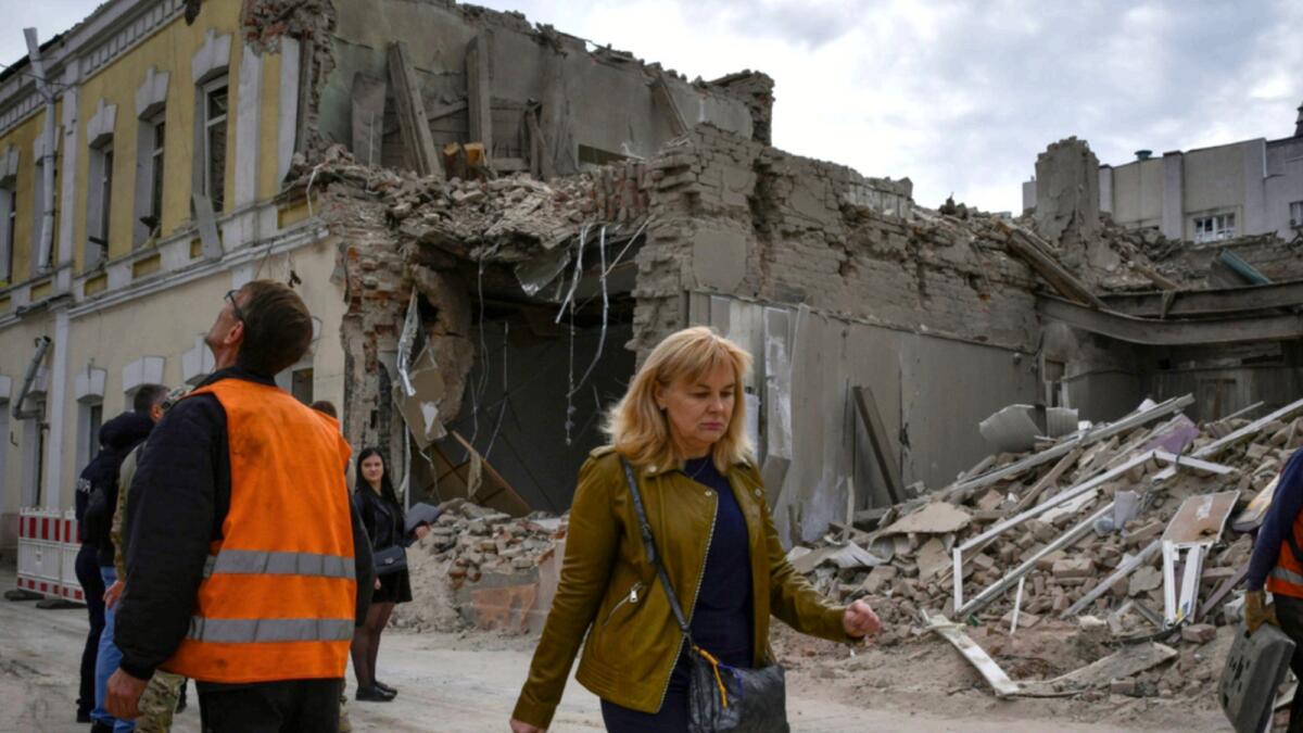 People pass by heavily damaged buildings after latest Russian rocket attack in Dnipro, Ukraine. — AP