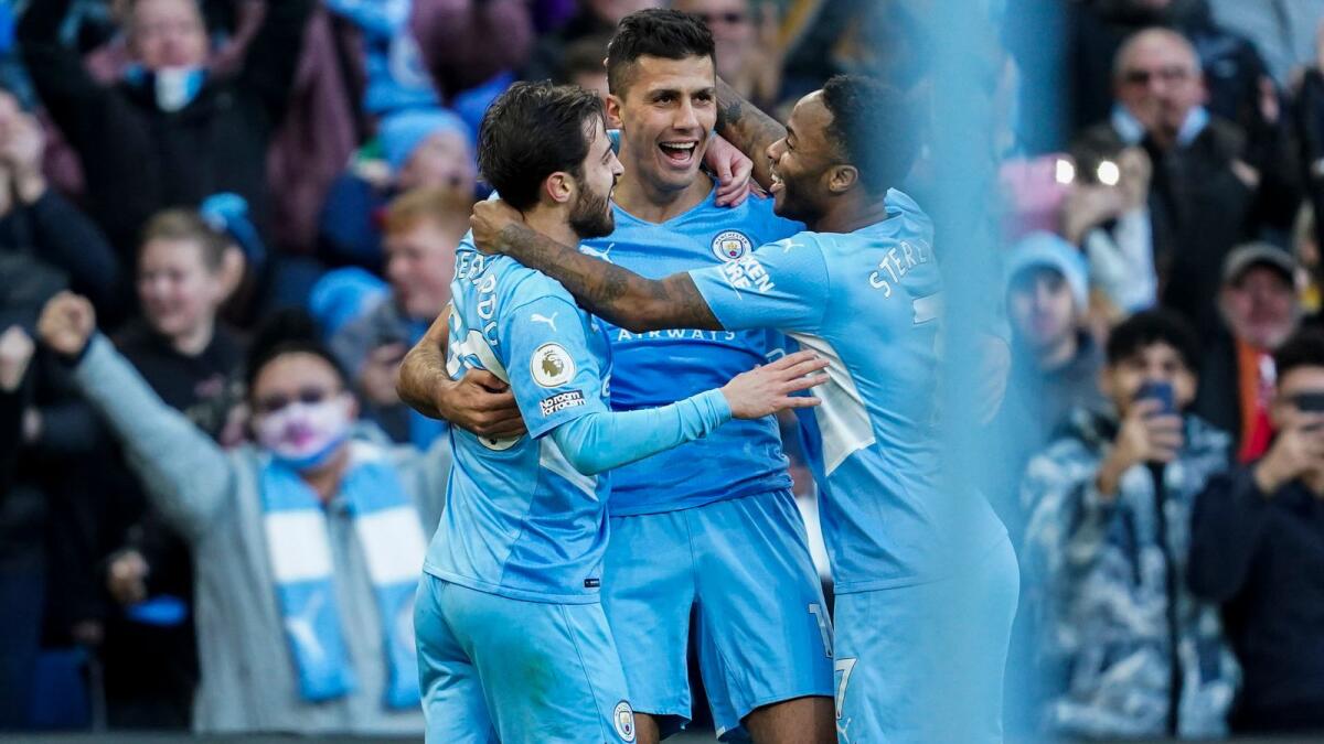 Manchester City's Rodrigo (centre) is congratulated by teammates Bernardo Silva and Raheem Sterling (right) after scoring a goal. (AP)