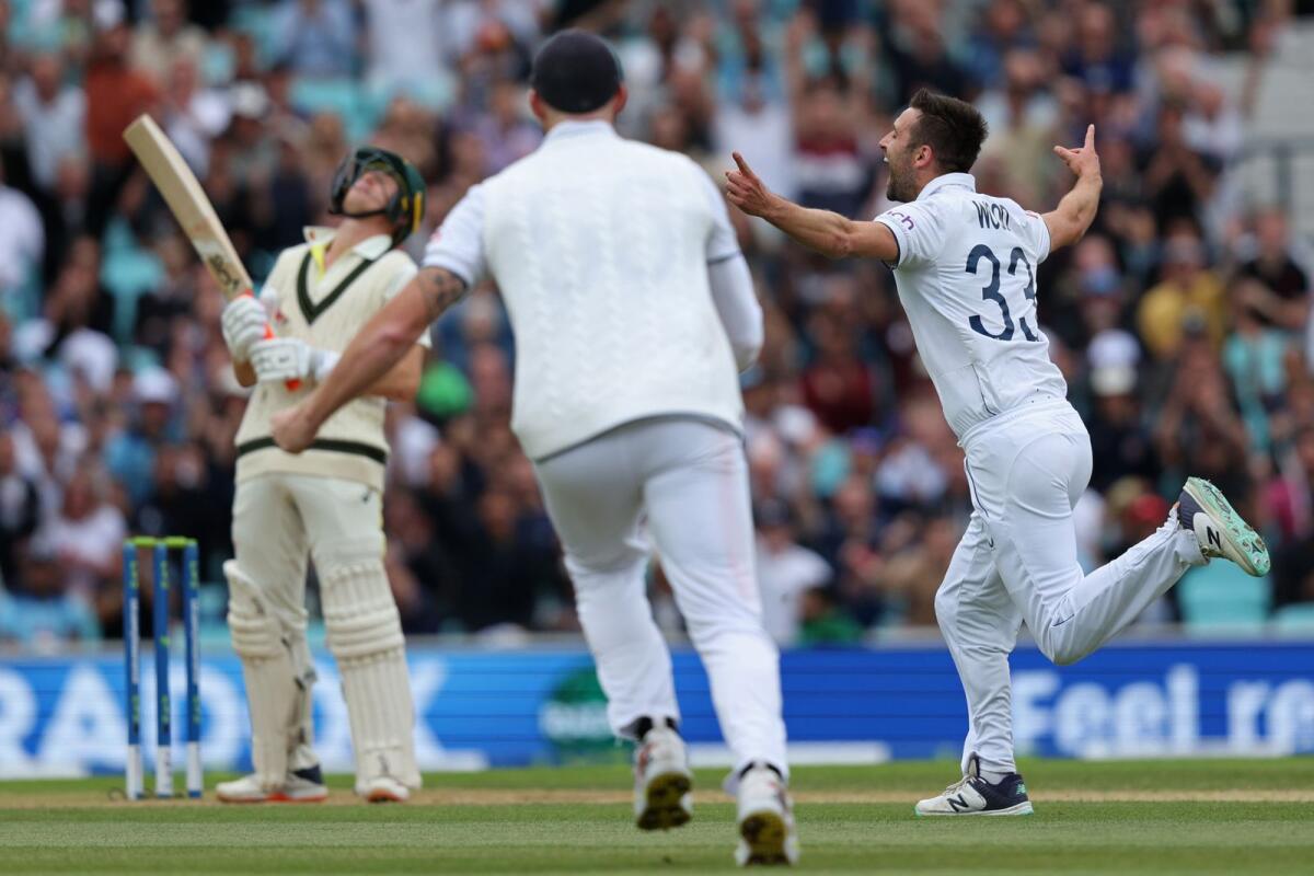 England's Mark Wood (right) celebrates after taking the wicket of Australia's Marnus Labuschagne on day five of the fifth Ashes Test at The Oval. — AFP