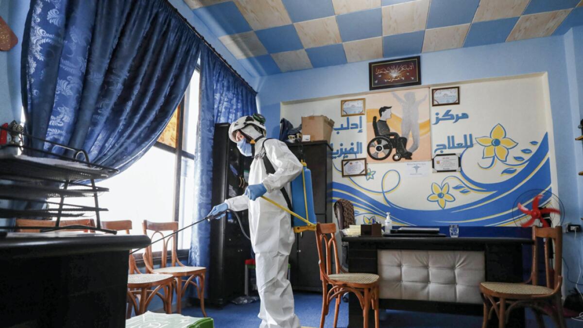 A member of the Syrian Civil Defence, also known as the 'White Helmets' disinfects a room at a physiotherapy centre in Syria's rebel-held northwestern city of Idlib, on July 11, 2020. A first case of coronavirus was recorded in northwest Syria on July 9, an opposition official said, reviving fears of disaster if the pandemic reached the rebel bastion's displacement camps. Photo: AFP