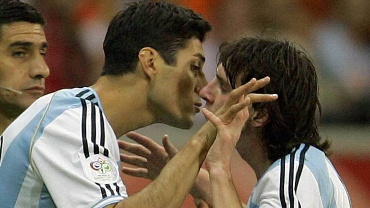 The Barcelona forward gets up close and personal with Argentina team-mate Julio Cruz as he is substituted against Holland in June, 2006.