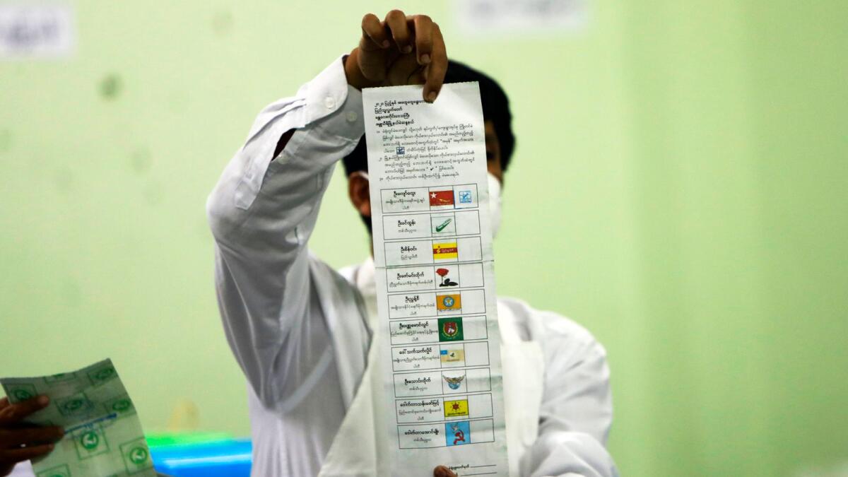 An official of the Union Election Commission counts ballots at a polling station in Naypyitaw, Myanmar. — AP file