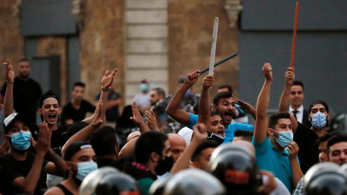 Supporters of former Lebanese prime minister Saad Hariri shout slogans against anti-government protesters in downtown Beirut, Lebanon, on Wednesday.