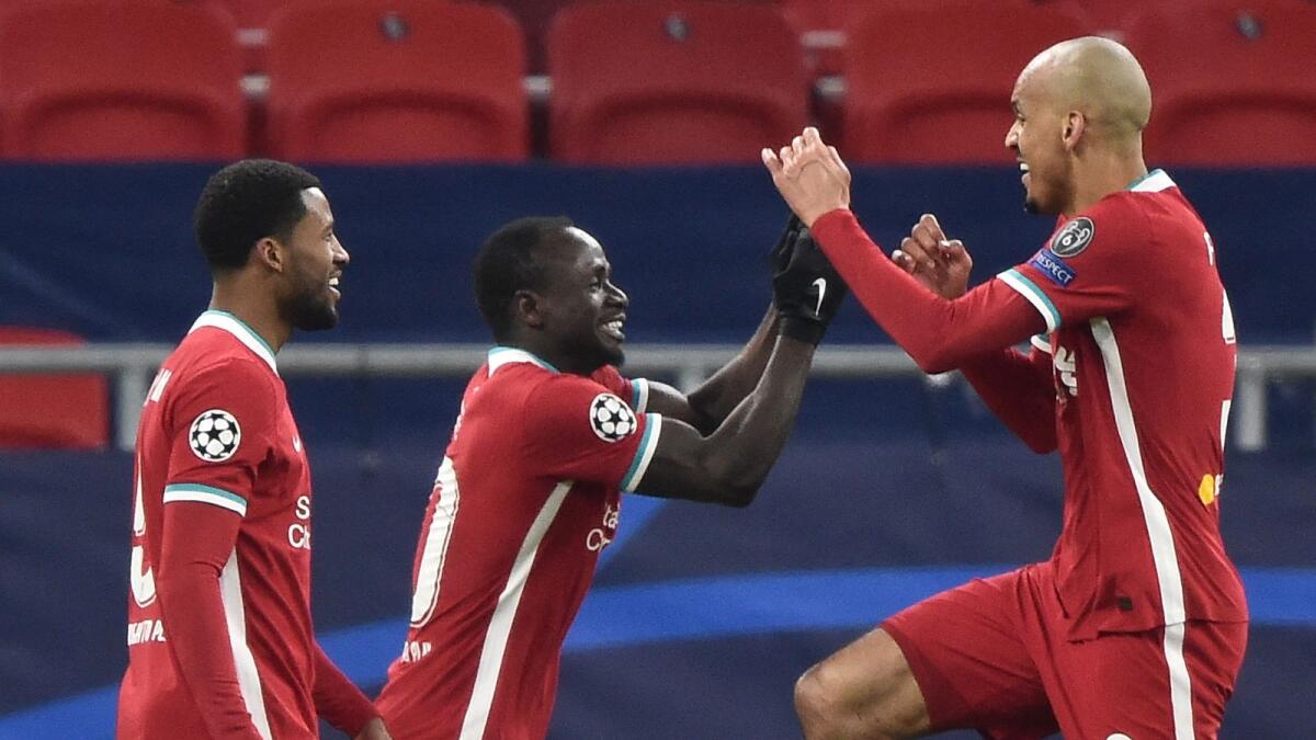 Liverpool's Sadio Mane (centre) celebrates with teammates after scoring a goal during the Uefa Champions league Last 16 2nd Leg match against RB Leipzig. — AFP