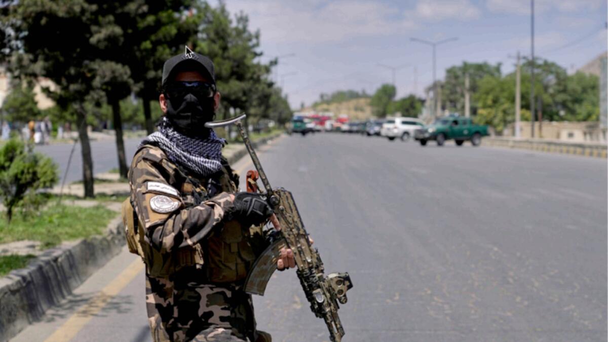 A Taliban fighter stands guard in Kabul. — AP file