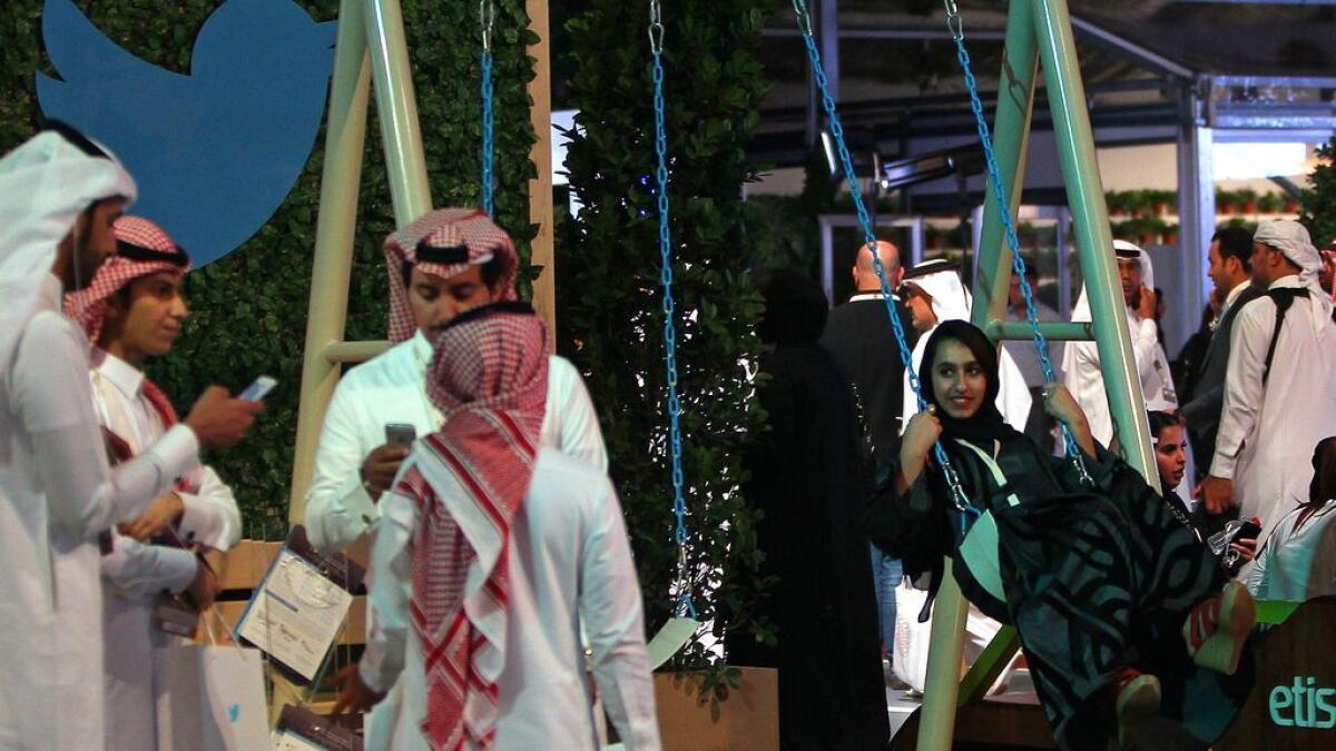 People swinging at the Twitter stand at Arab Media Forum.
