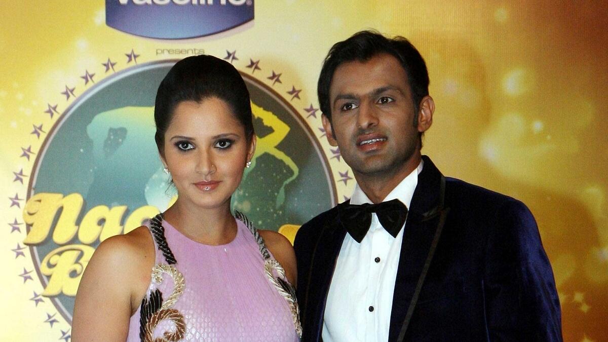 Indian tennis player Sania Mirza (left) poses for a photo with husband Pakistani cricketer Shoaib Malik (right) during an event in Mumbai.- AFP