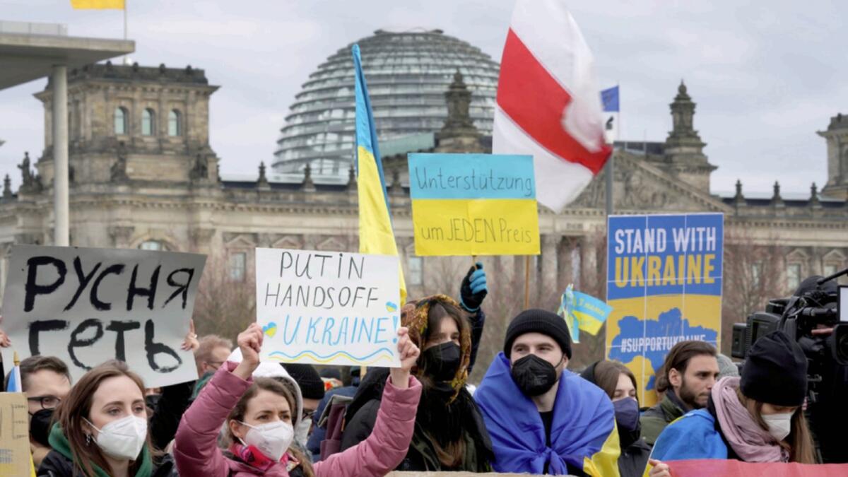 People attend a pro-Ukraine protest rally in front of the Chancellery close to the Reichstag building, background, in Berlin, Germany. — AP