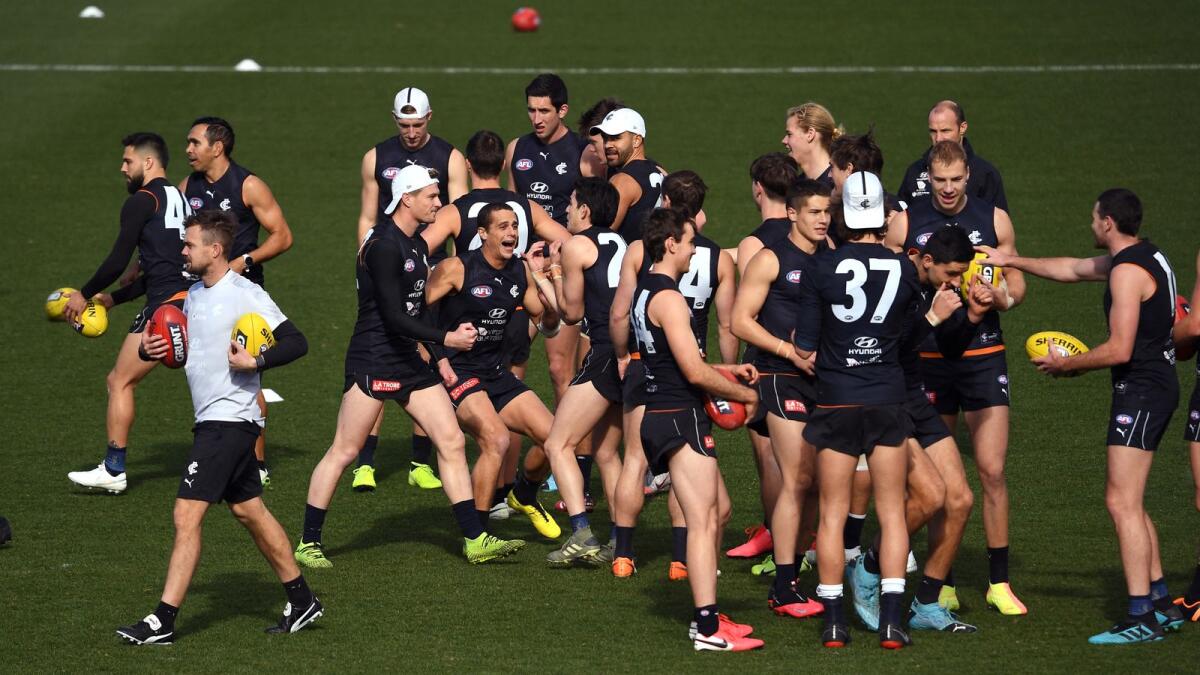 File photo shows Aussie Rules players training in a Melbourne stadium. Photo: AFP