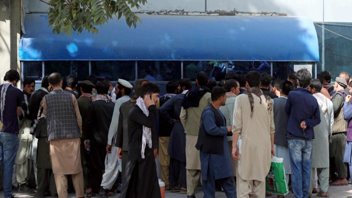 Afghans wait in long lines for hours to try to withdraw money, in front of Kabul Bank, in Kabul. — AP