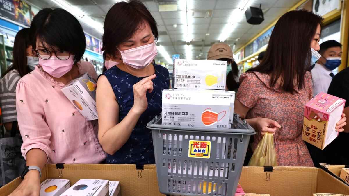 People buy boxes of protective face masks following the outbreak of coronavirus disease (COVID-19), in Taipei, Taiwan, May 12, 2021. REUTERS/Ann Wang