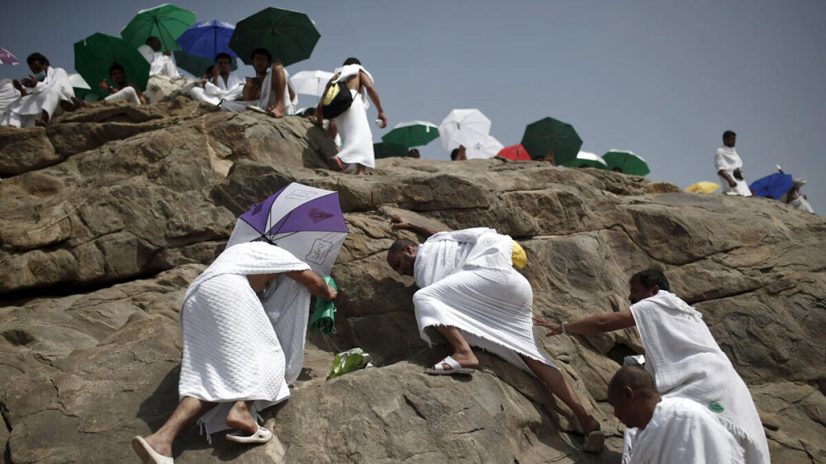 Pilgrims climb Mount Arafat during the Haj pilgrimage.