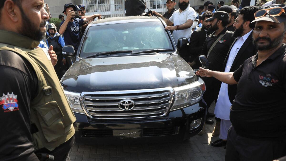 A vehicle carrying Pakistan's former Prime Minister Imran Khan drives outside the High Court in Islamabad on Thursday. — Reuters