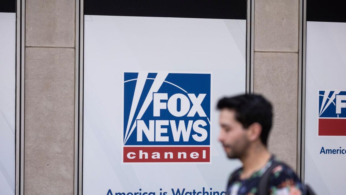 A person walks past the Fox News Headquarters in New York, on April 12. — AP