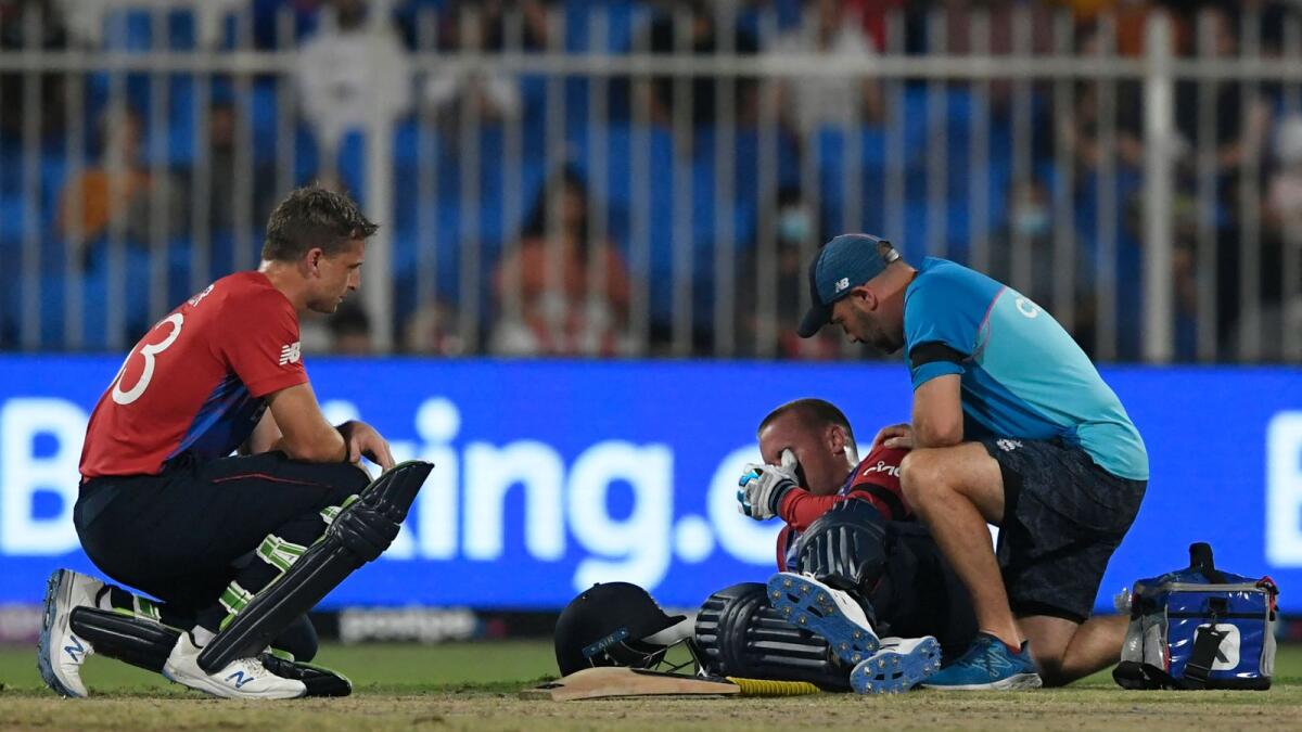 England's Jason Roy (centre) lies on the ground in pain following an injury during the game against South Africa in Sharjah. — AFP