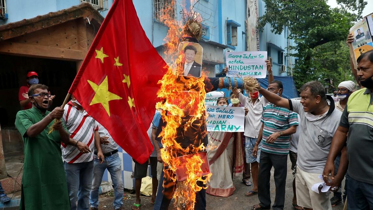 Demonstrators shout slogans as they burn an effigy depicting Chinese President Xi Jinping during a protest against China, in Kolkata, India, June 18, 2020.