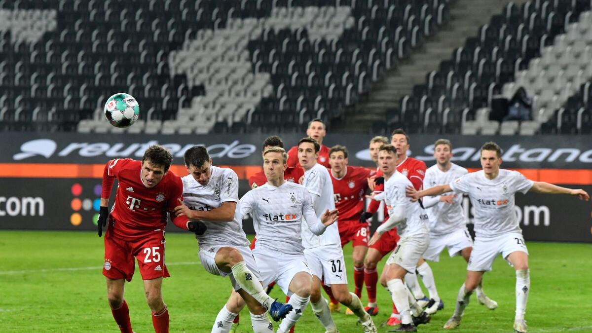 Bayern's Thomas Mueller (left) tries to head the ball during the German Bundesliga  match against Borussia Moenchengladbach.— AP