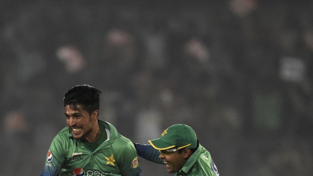 Mohammad Amir (left) reacts after dismissing India’s Suresh Raina during the Asia Cup match on Saturday, — AFP
