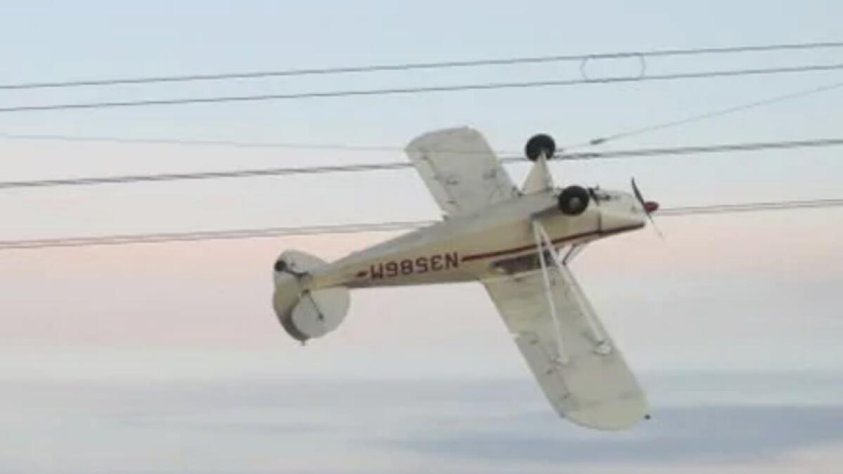 Pilot crashes plane into high-voltage power lines, gets entangled