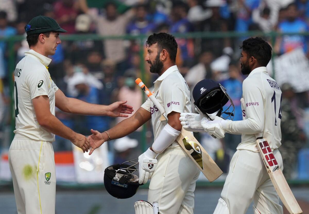 Indian batters Cheteshwar Pujara and Srikar Bharat greet Australian captain Pat Cummins after the end of the second Test in New Delhi. — PTI