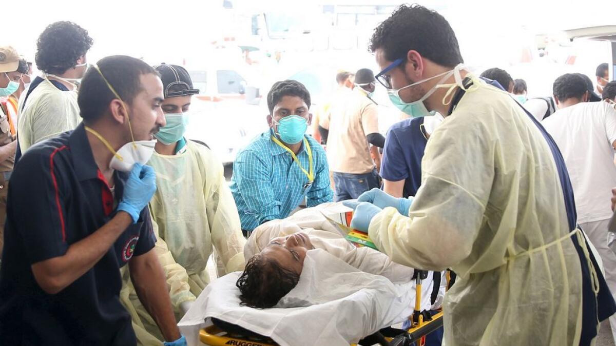 Medical personnel tend to a wounded pilgrim following a crush caused by large numbers of people pushing at Mina.