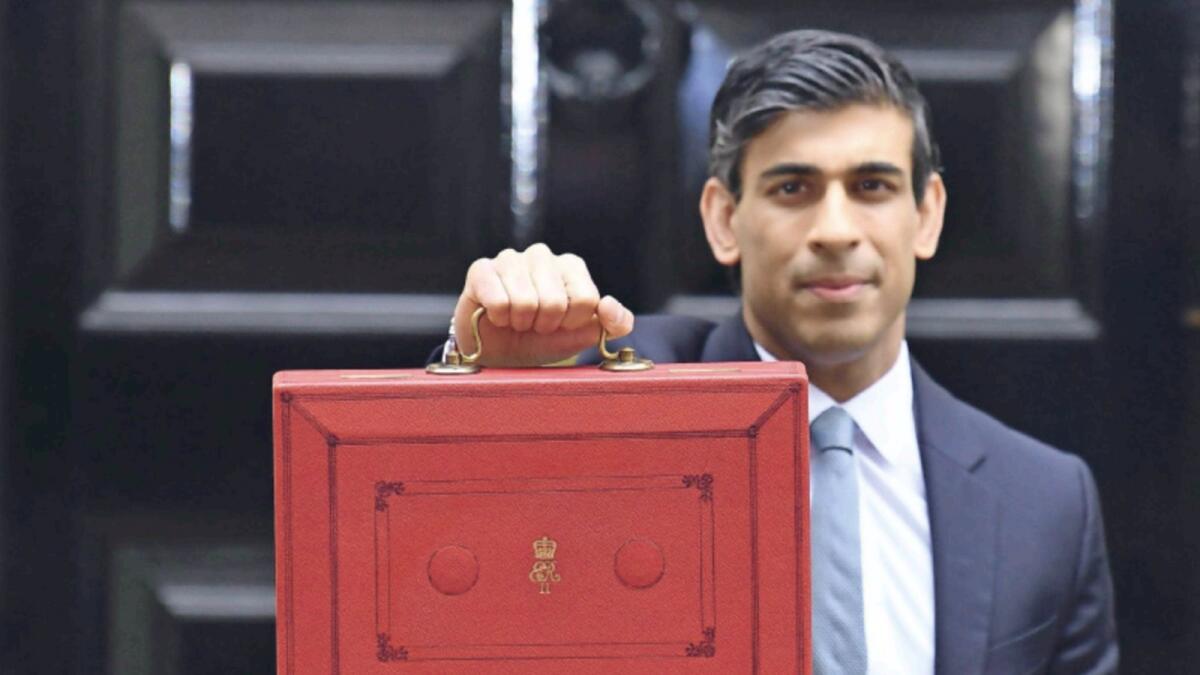 Britain's Chancellor of the Exchequer Rishi Sunak poses with the Budget Box as he leaves 11 Downing Street before presenting the government's annual budget to Parliament. — AFP file
