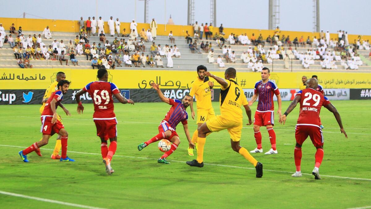 Players tackling for the ball during the Etisalat cup football match between Al Wasl and Al Shaab at Al Wasl Sports club in Dubai on Friday   
